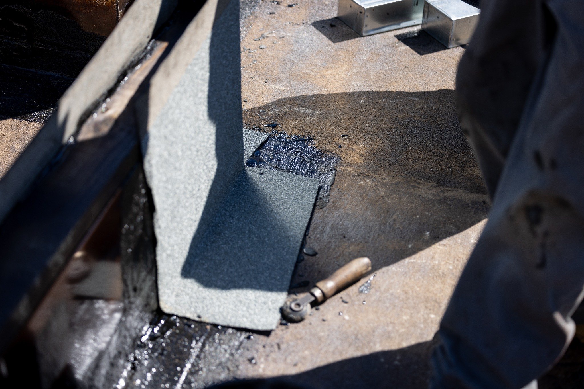 up close of roofing material with tar